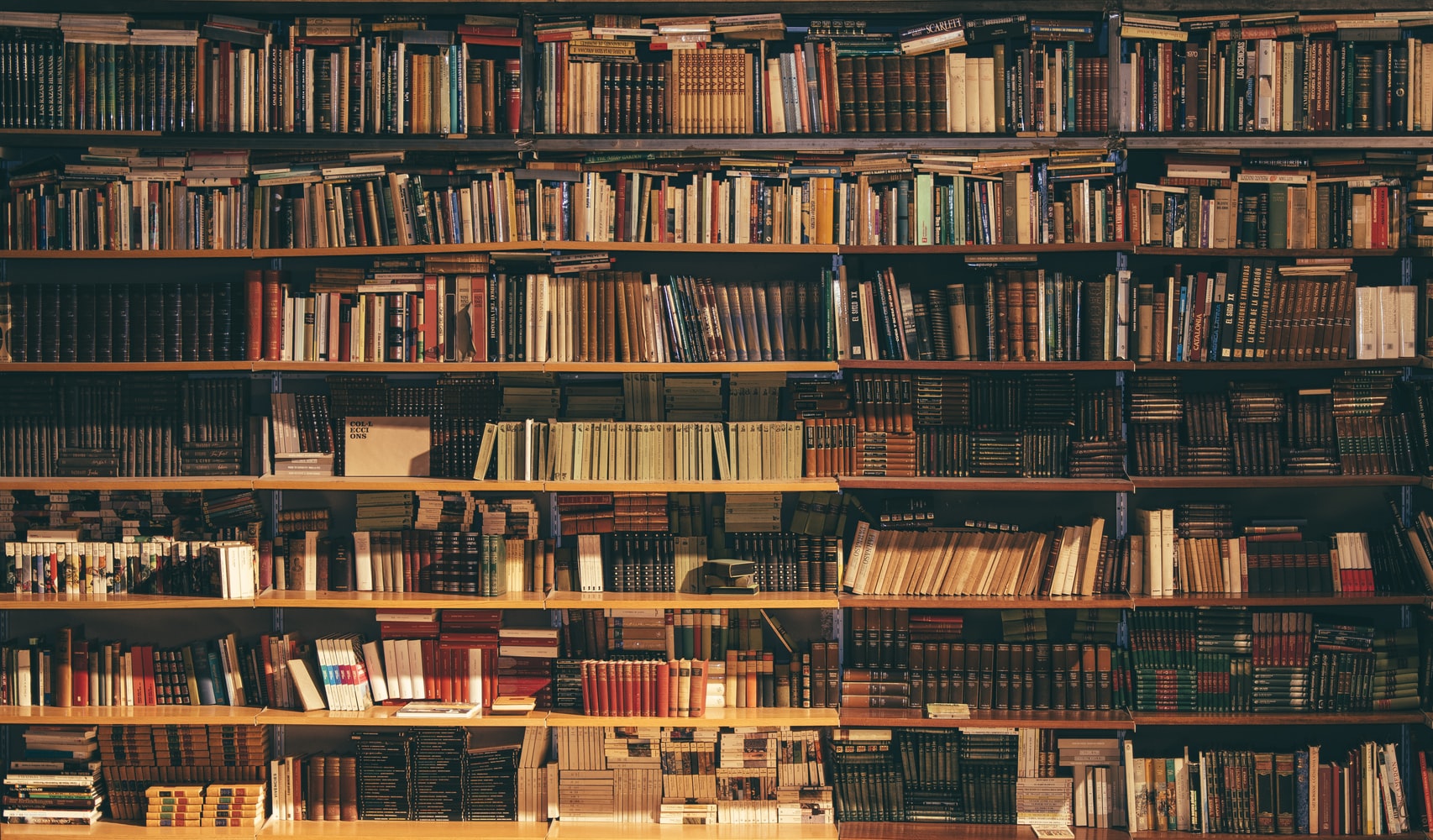 A photo of a bookcase completely filled with various books.